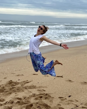 A photo of Joy jumping on the beach. 