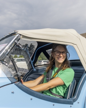 A photo of Taylor in an antique car. 