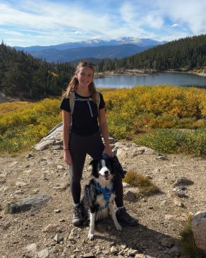A photo of Taylor on a hike with her dog. 