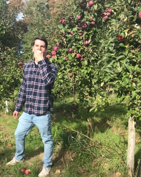 A photo of Michael in an orchard. 