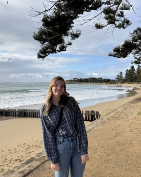A photo of Emily on the shore of a Melbourne beach. 
