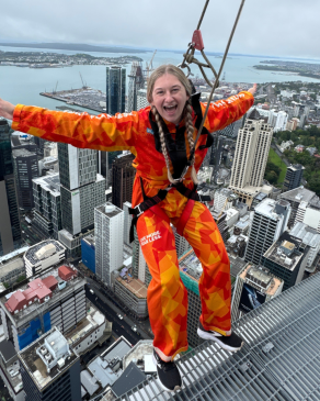 A photo of Kayla leaning off a building in New Zealand