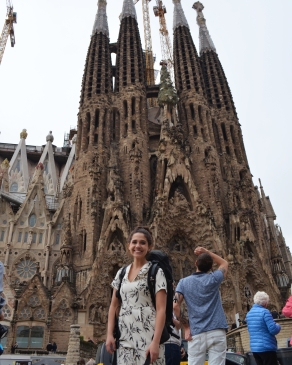 A photo of Tiffany posing with a historical structure in Barcelona. 