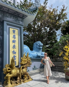 A photo of Lex posing in front of a structure in Vietnam. 