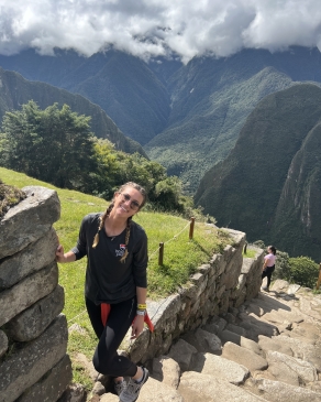 A photo of Micaela near steps in Peru. 