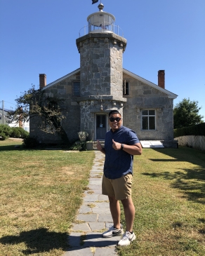 A photo of Bryan in front of a historic building. 