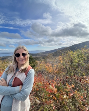 Lexie posing with the Maine mountainside behind her. 