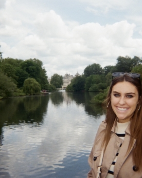 Nicole posing with a river in London. 