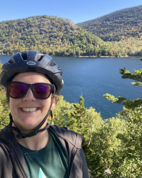 A photo of Whitney biking at Acadia National Park. 