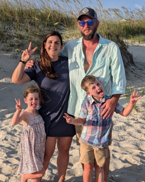 A photo of Whitney and her family on the beach. 