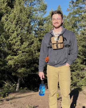 Jack posing in front of shrubs in the Grand Teton. 