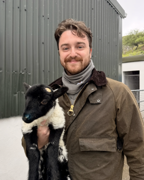 Jack holding a baby goat in Ireland. 