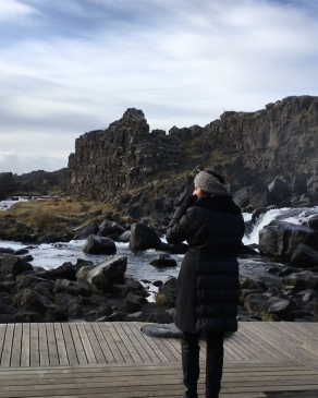 Amee stares at a mountain range in Iceland. 