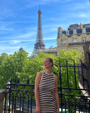 Delaney posing with the Eiffel tower in Paris. 