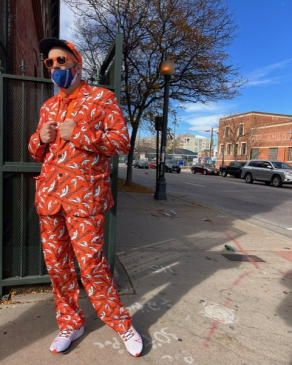 Mike posing in a bright suit in Denver. 