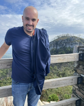 Mike poses in front of a mountain range in Wyoming. 