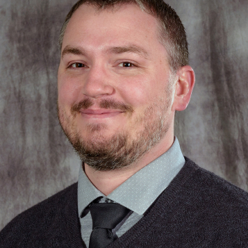 A headshot of Mike Gussiaas